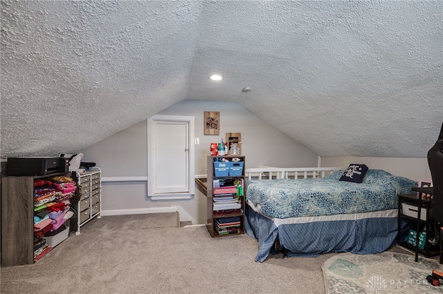 carpeted bedroom with vaulted ceiling and a textured ceiling