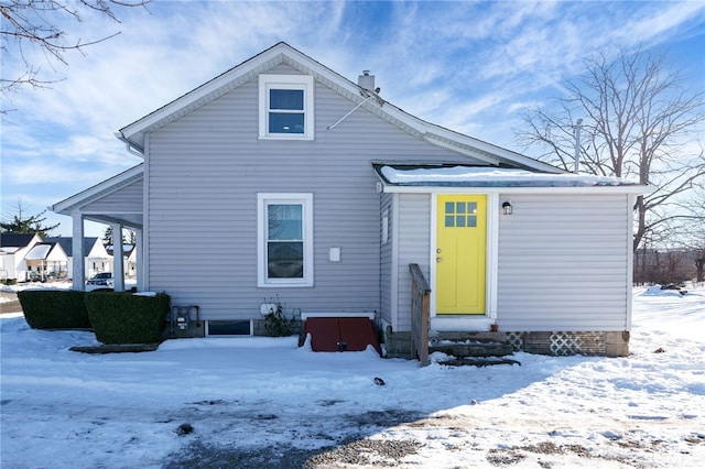 view of snow covered rear of property