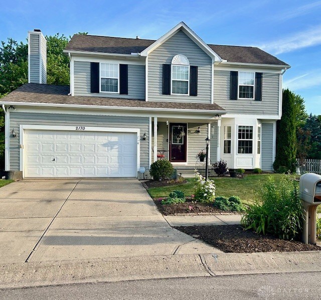 view of front of home with a garage and a front yard