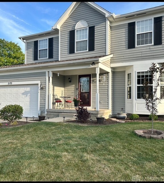 view of front of house with covered porch and a front yard