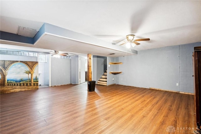 unfurnished living room featuring hardwood / wood-style flooring and ceiling fan