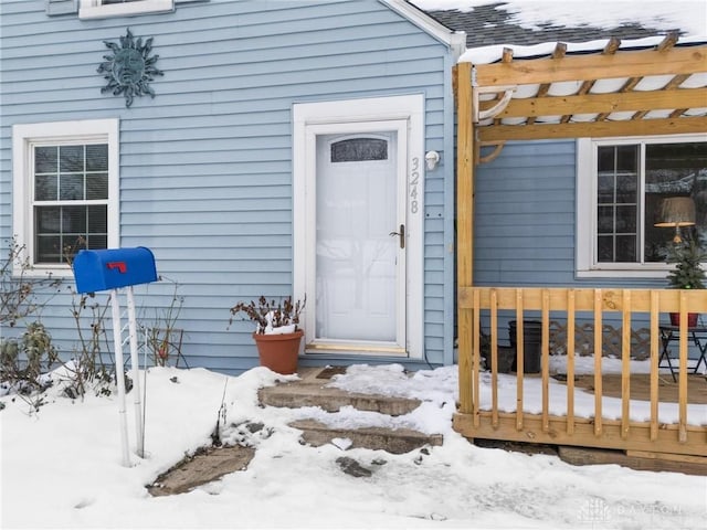 view of snow covered property entrance