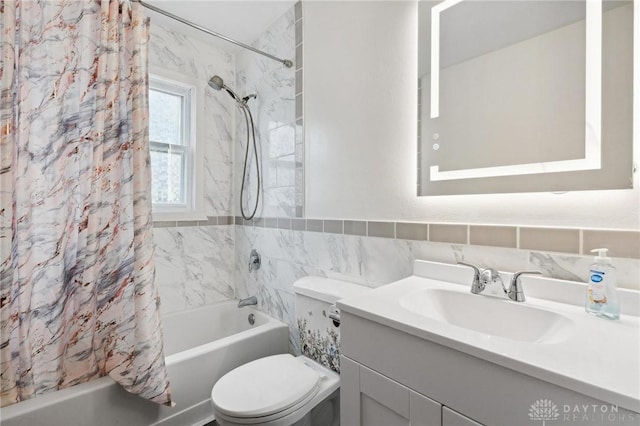 full bathroom with toilet, vanity, tile walls, backsplash, and shower / bath combo with shower curtain