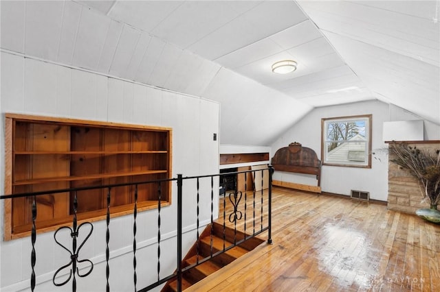 bonus room with vaulted ceiling and hardwood / wood-style flooring