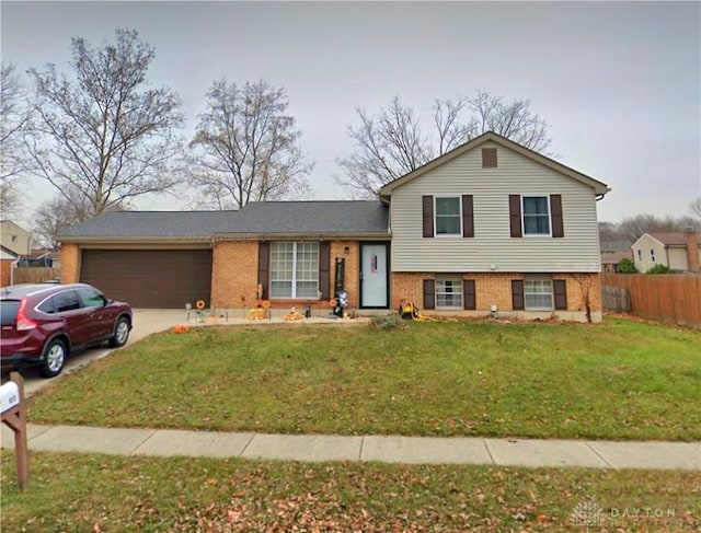 split level home featuring a front yard and a garage