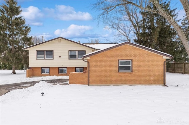 view of snow covered back of property