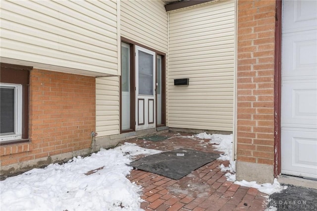 view of snow covered property entrance