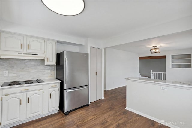 kitchen with tasteful backsplash, black electric stovetop, stainless steel refrigerator, white cabinetry, and dark hardwood / wood-style flooring