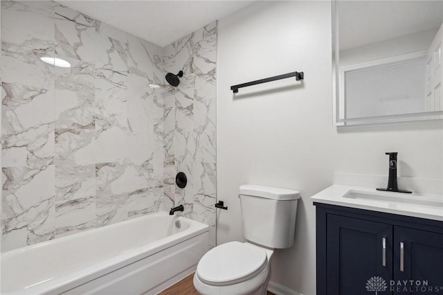 full bathroom featuring toilet, tiled shower / bath combo, hardwood / wood-style flooring, and vanity