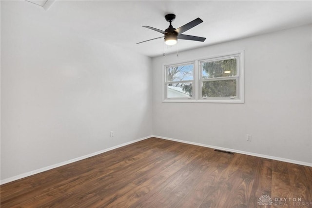 unfurnished room featuring ceiling fan and dark wood-type flooring