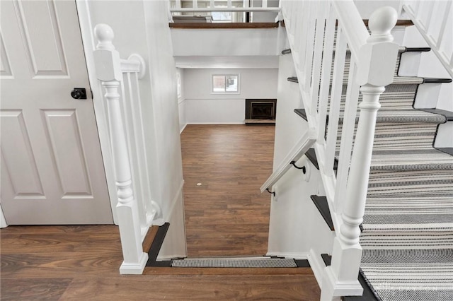 stairs featuring hardwood / wood-style flooring