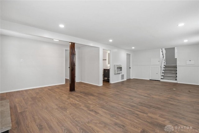 basement with heating unit and dark wood-type flooring