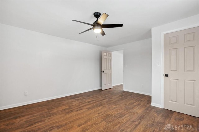 empty room featuring ceiling fan and dark hardwood / wood-style floors