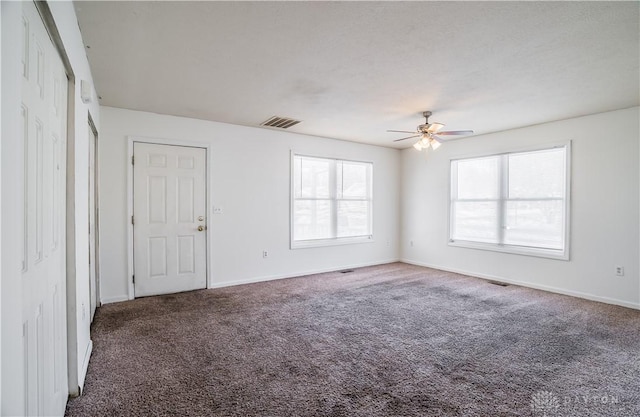 carpeted empty room featuring ceiling fan