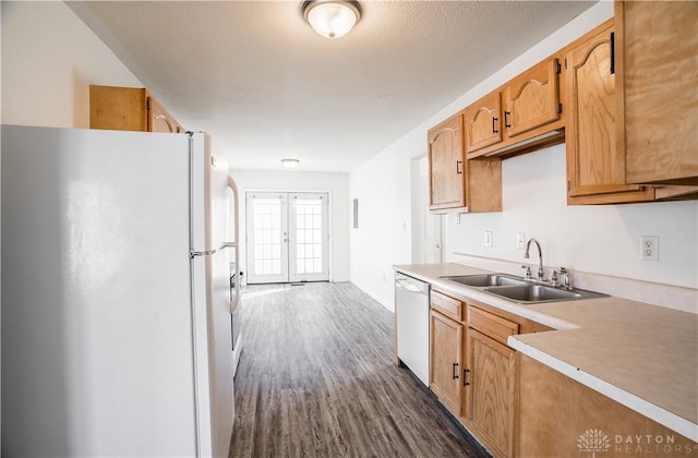 kitchen featuring sink, white appliances, dark hardwood / wood-style flooring, and french doors