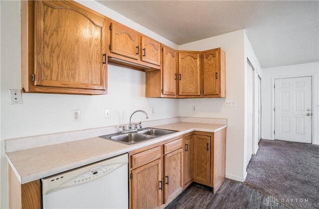 kitchen featuring sink, a textured ceiling, dark hardwood / wood-style floors, and dishwasher