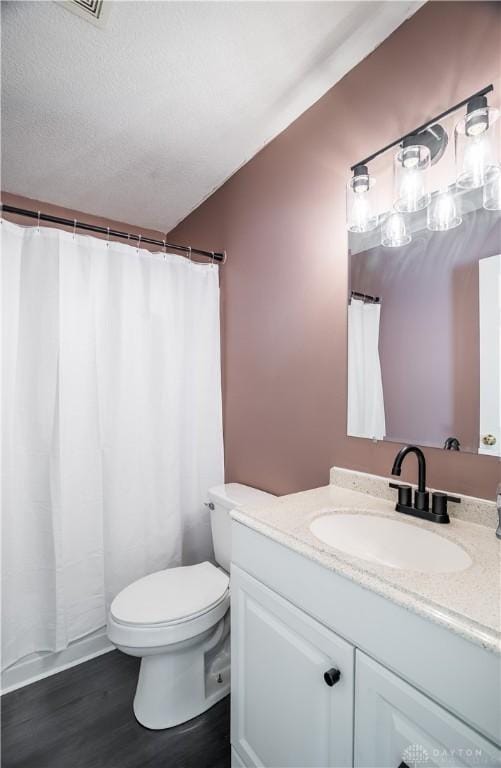 bathroom featuring toilet, vanity, and wood-type flooring