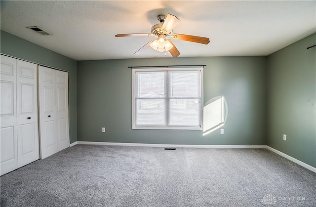 unfurnished bedroom featuring ceiling fan, carpet flooring, and a closet