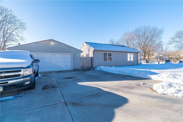 exterior space featuring a garage and an outbuilding