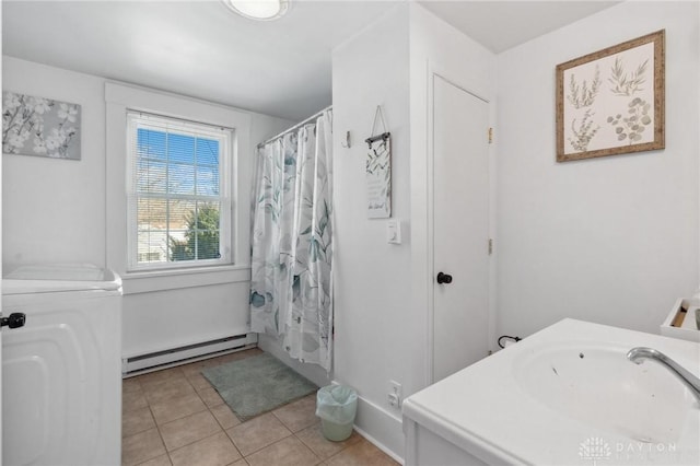 bathroom with shower / bath combo, a baseboard radiator, vanity, tile patterned flooring, and washer / clothes dryer