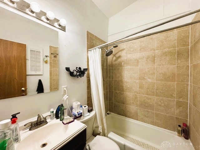 full bathroom featuring shower / bath combo with shower curtain, toilet, and vanity