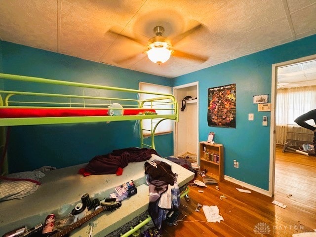 bedroom with ceiling fan and wood-type flooring