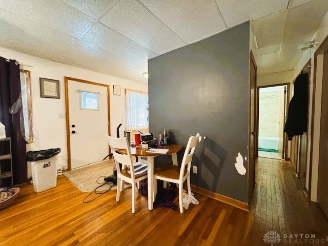 dining room featuring a paneled ceiling and hardwood / wood-style floors