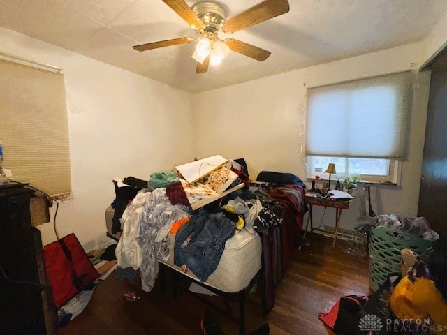 bedroom with ceiling fan and dark hardwood / wood-style flooring