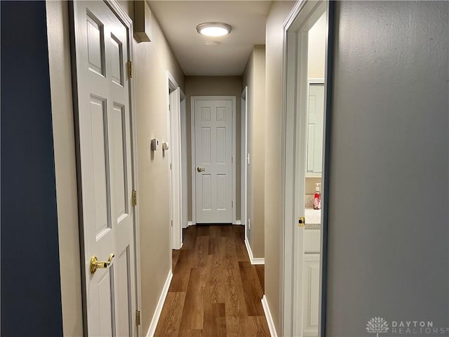 corridor with dark wood-type flooring