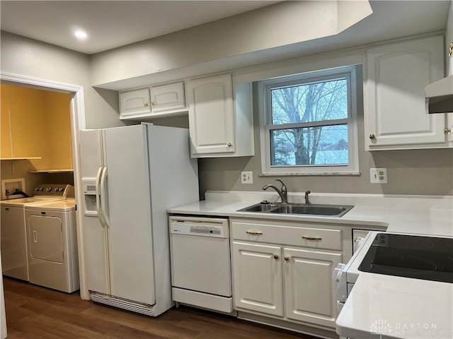 kitchen featuring white cabinetry, washer and clothes dryer, white appliances, dark hardwood / wood-style flooring, and sink