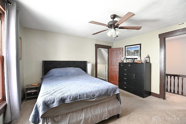 bedroom featuring ceiling fan, baseboards, and light colored carpet