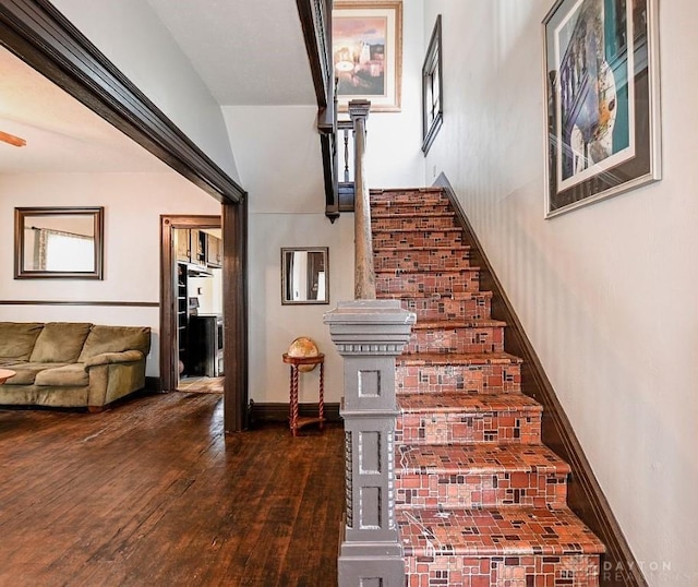 stairs with hardwood / wood-style flooring, baseboards, and a ceiling fan