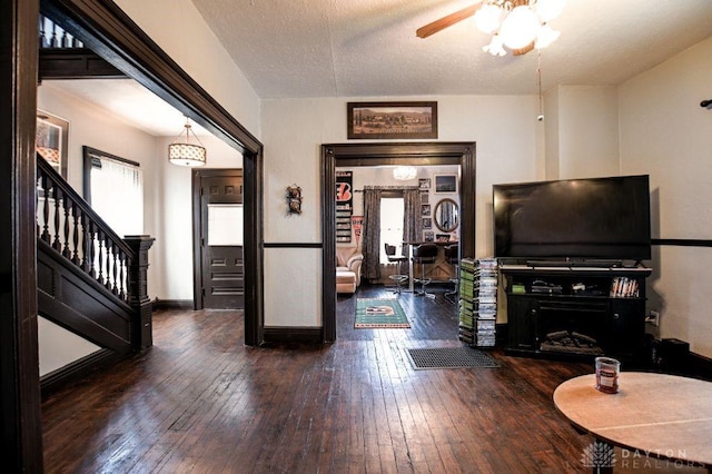 entryway featuring stairs, a textured ceiling, plenty of natural light, and hardwood / wood-style flooring