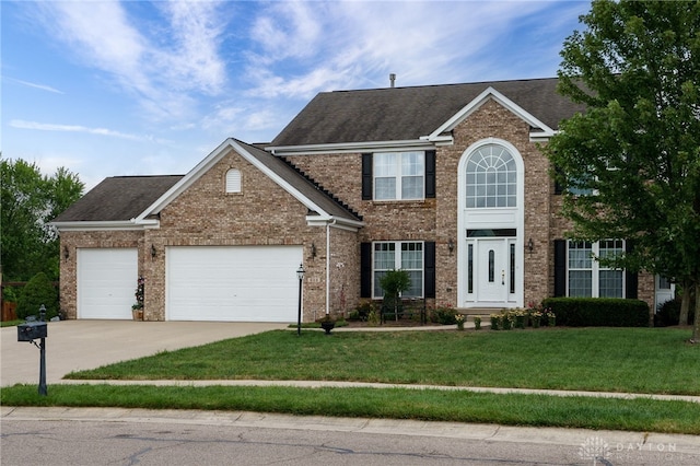 view of front of home with a garage and a front lawn