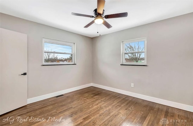 empty room with ceiling fan and wood-type flooring