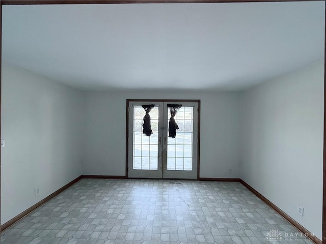 spare room featuring french doors