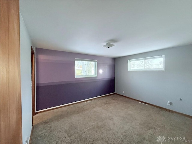 carpeted spare room with a wealth of natural light