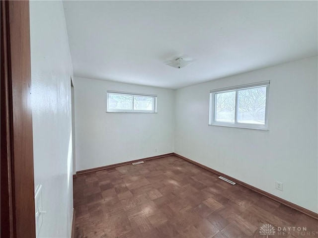 unfurnished room with parquet flooring