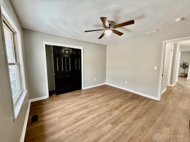 interior space featuring ceiling fan, a closet, and light hardwood / wood-style floors