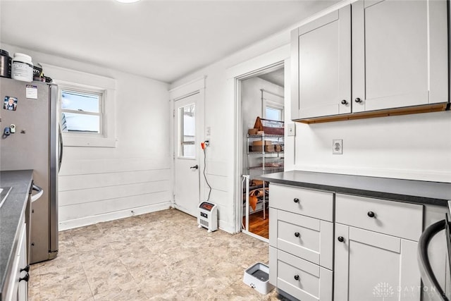 kitchen with white cabinets and stainless steel refrigerator