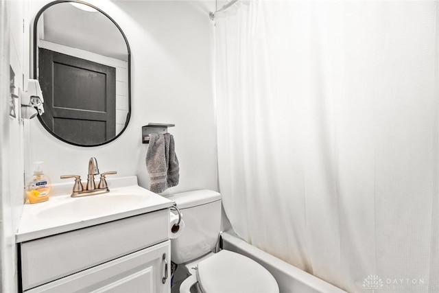 full bathroom featuring toilet, vanity, and shower / tub combo with curtain