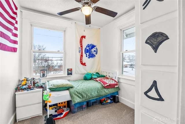 bedroom featuring ceiling fan and carpet