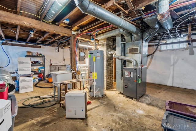 basement with heating unit, sink, and gas water heater