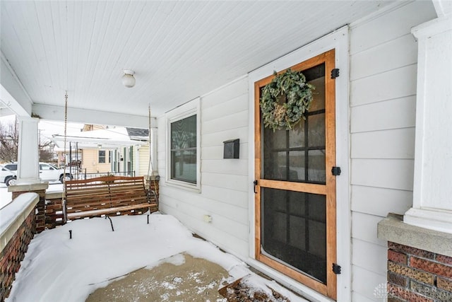 view of snow covered property entrance