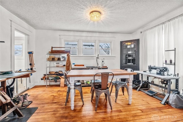 office space featuring a textured ceiling and light hardwood / wood-style flooring