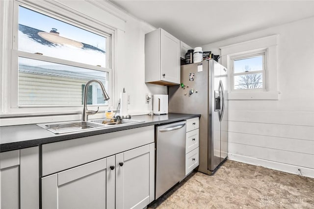 kitchen featuring appliances with stainless steel finishes, white cabinetry, and sink