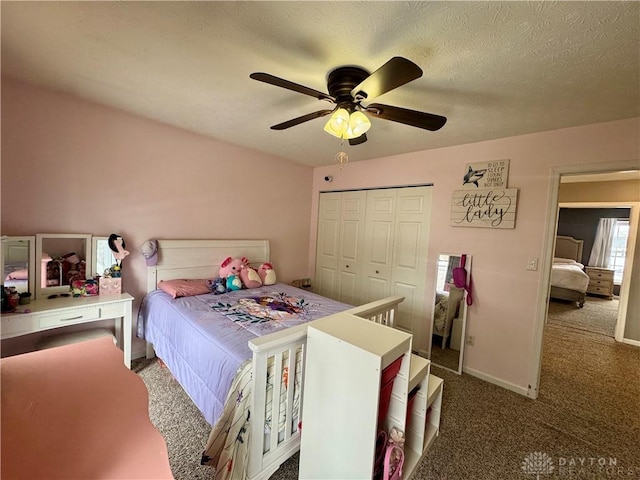 carpeted bedroom featuring ceiling fan and a closet