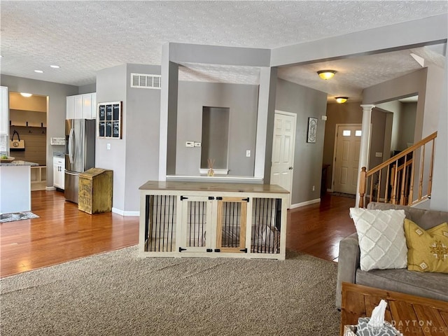 unfurnished living room featuring carpet floors and a textured ceiling