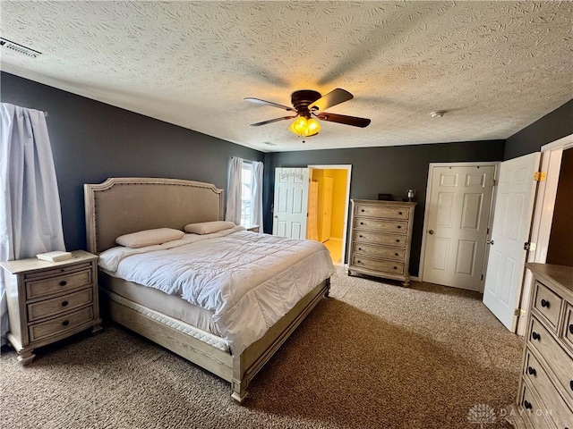 carpeted bedroom with ceiling fan, a textured ceiling, and connected bathroom