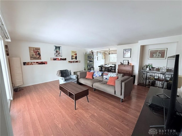 living room featuring hardwood / wood-style floors and a notable chandelier